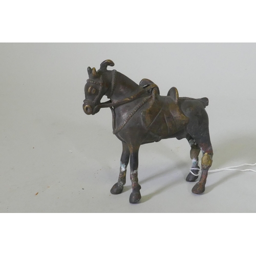 103 - An Eastern bronze figure of a horse with saddle, 10cm high