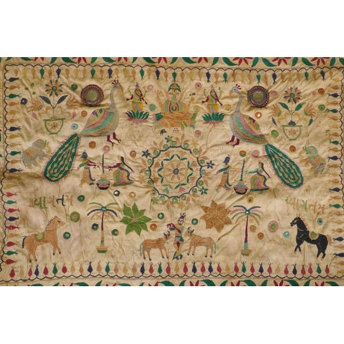 105 - A C19th Indian embroidered wall hanging decorated with depictions of Ganesh, peacocks, elephants, co... 