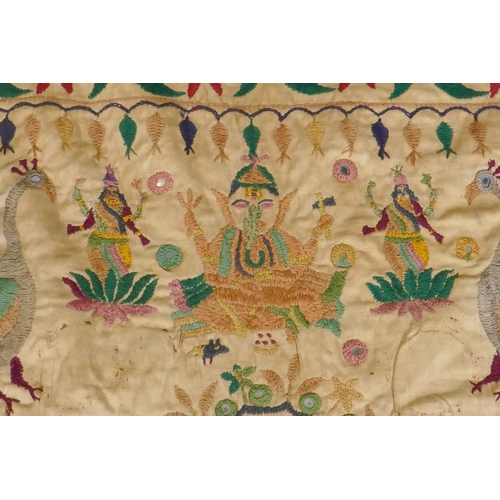 105 - A C19th Indian embroidered wall hanging decorated with depictions of Ganesh, peacocks, elephants, co... 