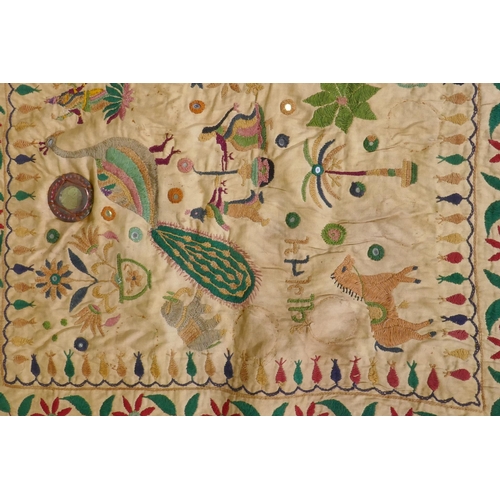 105 - A C19th Indian embroidered wall hanging decorated with depictions of Ganesh, peacocks, elephants, co... 