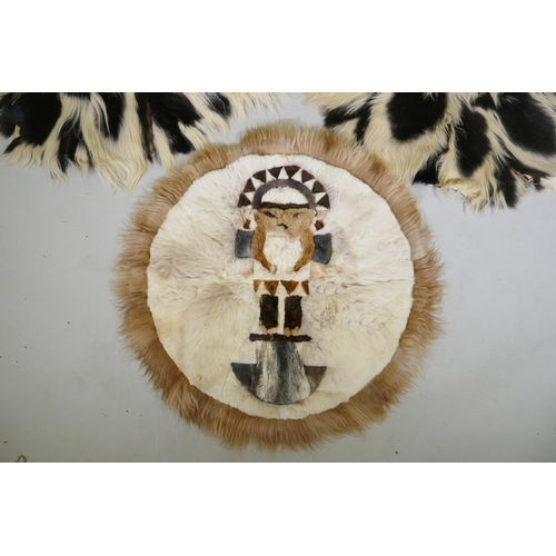 1050 - A pair of circular animal fur rugs, and another with lion design, largest 120cm diameter