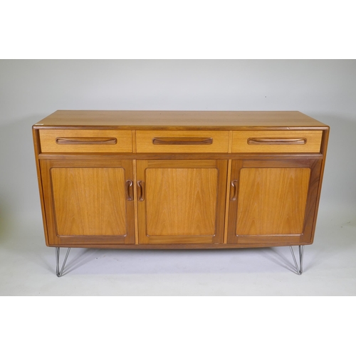 1052 - A mid century G-Plan Fresco sideboard/buffet, with three drawers over three cupboards, raised on hai... 