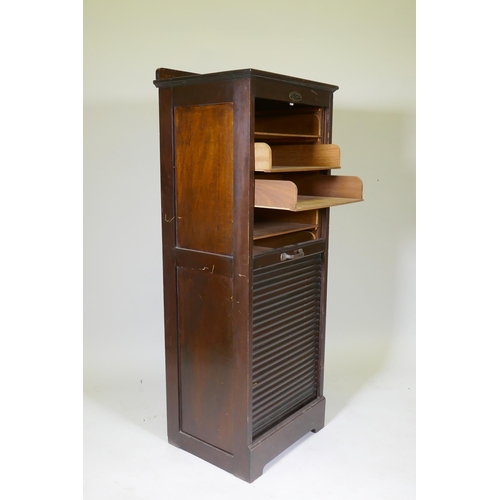 1053 - An early C20th oak tambour fronted music/filing cabinet, by Wolfe & Hollander Ltd of London, 48 ... 