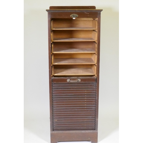 1053 - An early C20th oak tambour fronted music/filing cabinet, by Wolfe & Hollander Ltd of London, 48 ... 