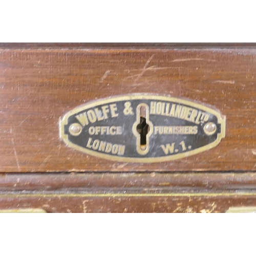 1053 - An early C20th oak tambour fronted music/filing cabinet, by Wolfe & Hollander Ltd of London, 48 ... 