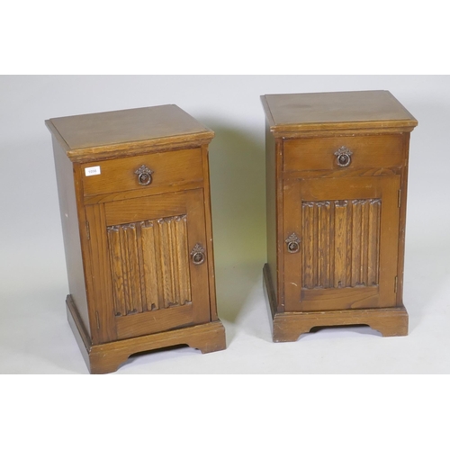 1056 - A pair of 'Maple' oak bedside chests, with single drawer over a cupboard, with linen fold panel, rai... 