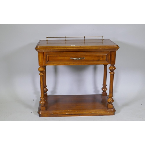 1068 - A walnut side table with brass galleried top, single drawer and undertier, united by turned supports... 