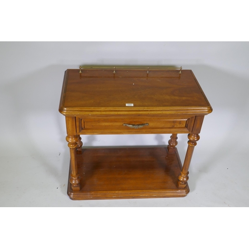 1068 - A walnut side table with brass galleried top, single drawer and undertier, united by turned supports... 