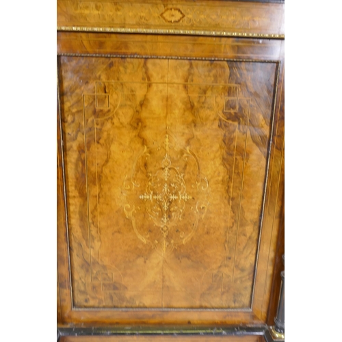 1071 - A Victorian inlaid figured walnut side cabinet, the mirrored back with galleried shelves, the base w... 