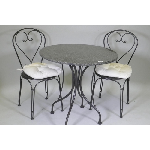 1072 - A granite top garden table and two chairs, 75cm diameter