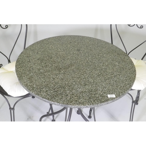 1072 - A granite top garden table and two chairs, 75cm diameter