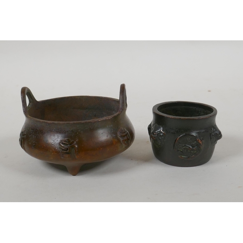 108 - A Chinese bronze two handled censer on tripod supports with character decoration, Xuande 6 character... 