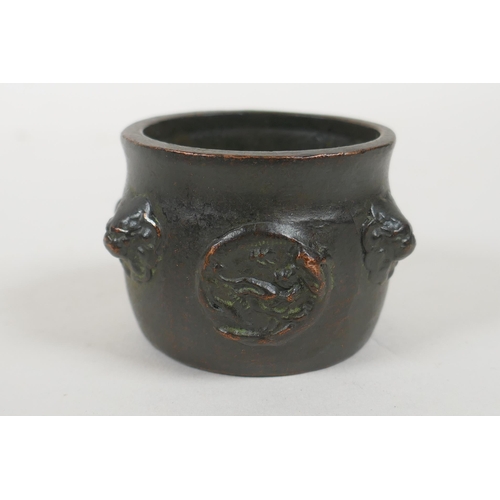 108 - A Chinese bronze two handled censer on tripod supports with character decoration, Xuande 6 character... 