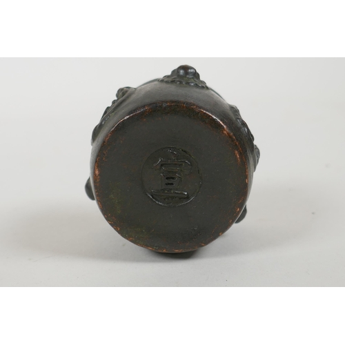 108 - A Chinese bronze two handled censer on tripod supports with character decoration, Xuande 6 character... 