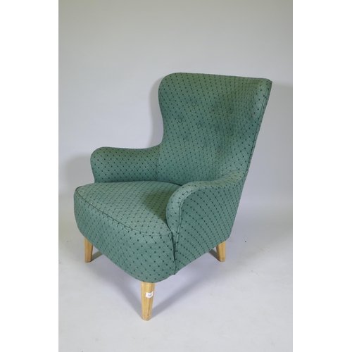 1081 - Theo Ruth, mid century armchair, raised on beechwood supports, stamped 'K', with good upholstery