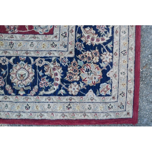 1082 - A good quality deep pile silk and wool carpet with Persian inspired design