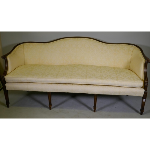 1090 - A Hepplewhite style humpback settee with scroll arms, raised on tapering supports, 200cm wide