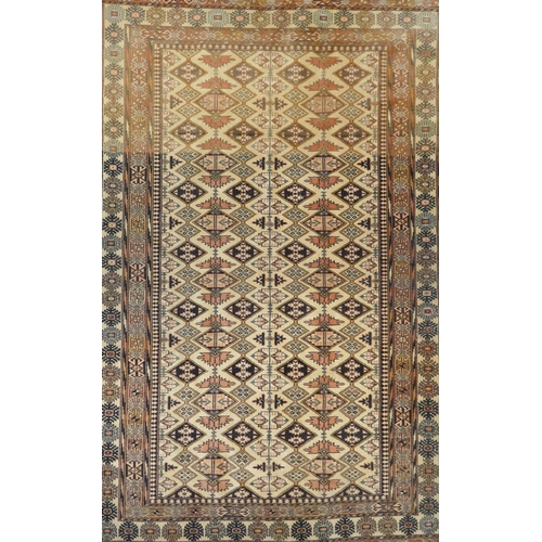 1095 - An Afghan faded red and black ground wool rug with Bokhara style design, 128 x 186cm