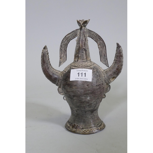 111 - An Eastern bronze head of Saturn with horned headdress, 20cm high