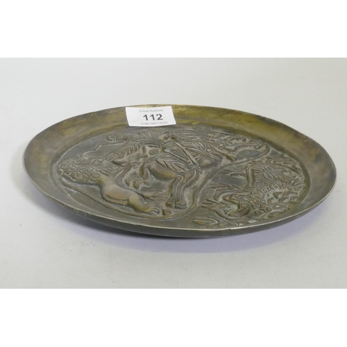 112 - A Sasanian style cast bronze dish with raised decoration depicting a lion hunt, 20cm diameter