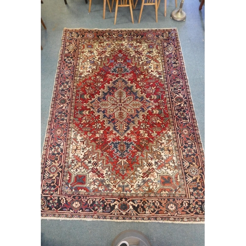 1123 - An antique Persian red and cream ground Heriz full pile carpet with black borders, 210 x 296cm