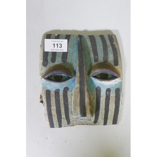 113 - A glazed ceramic mask plaque, early/mid C20th, 16cm long