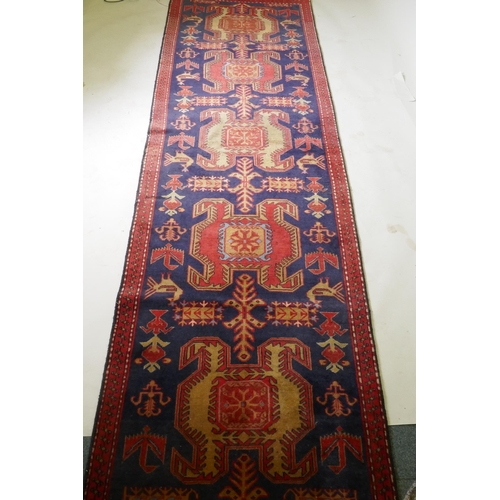 1131 - A fine woven Iranian runner, with bespoke medallion design on a rich blue field, 90 x 305cm