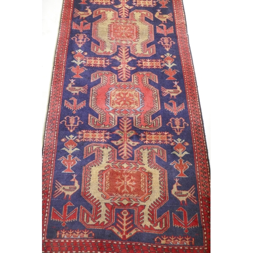 1131 - A fine woven Iranian runner, with bespoke medallion design on a rich blue field, 90 x 305cm