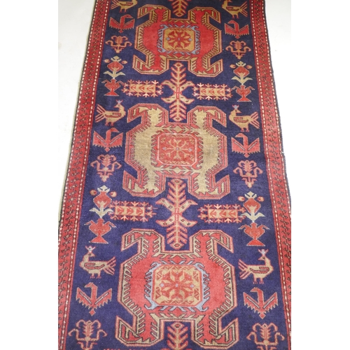 1131 - A fine woven Iranian runner, with bespoke medallion design on a rich blue field, 90 x 305cm