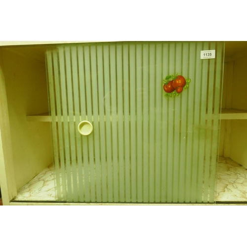 1135 - A mid century painted kitchen cabinet with etched sliding doors over a fall front and two cupboards,... 