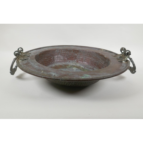 122 - An antique oriental bronze handled copper brazier with hammered decoration, 42cm diameter