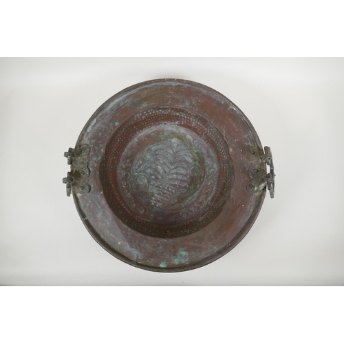 122 - An antique oriental bronze handled copper brazier with hammered decoration, 42cm diameter