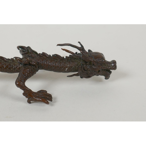 133 - A Japanese style bronze okimono dragon, 16cm long