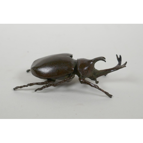 135 - A Japanese style bronze okimono rhinoceros beetle, 9cm long