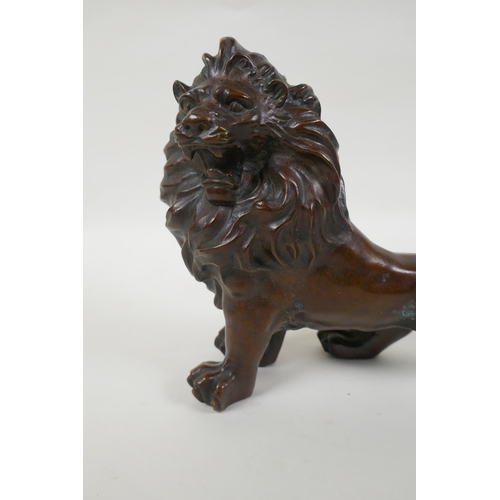 142 - A filled bronze statue of a lion, 28cm long