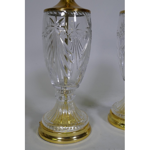 143 - A pair of cut glass table lamps with polished brass mounts and bases, 51cm high