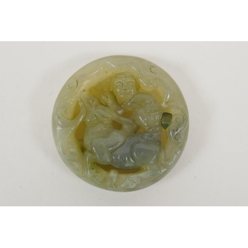 145 - A Chinese carved jade disc pendant in the form of a boy riding a buffalo, another similar of a monke... 