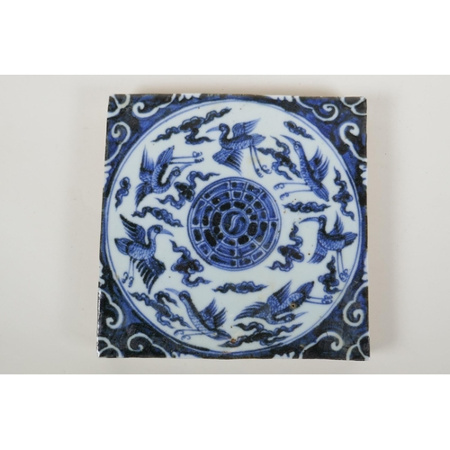 146 - A Chinese blue and white porcelain temple tile decorated with ducks and the yin yang symbol, 20 x 20... 