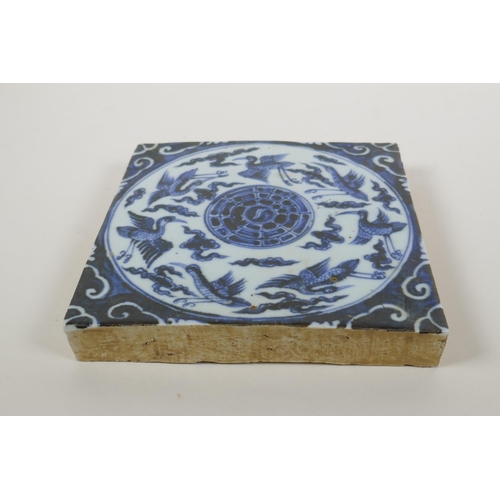 146 - A Chinese blue and white porcelain temple tile decorated with ducks and the yin yang symbol, 20 x 20... 