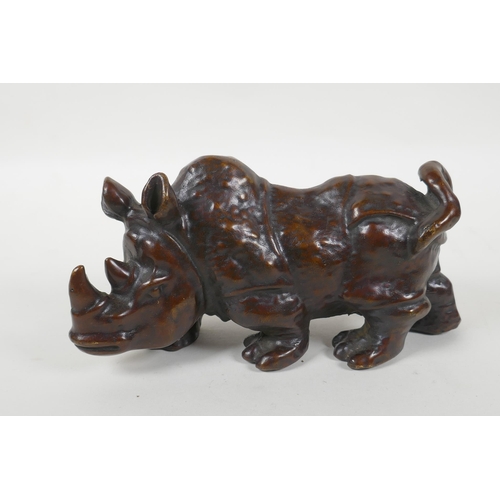 149 - A filled bronze rhinoceros, 20cm long