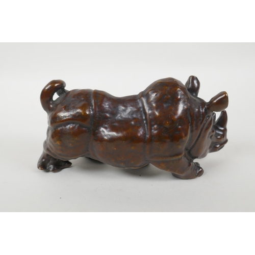 149 - A filled bronze rhinoceros, 20cm long