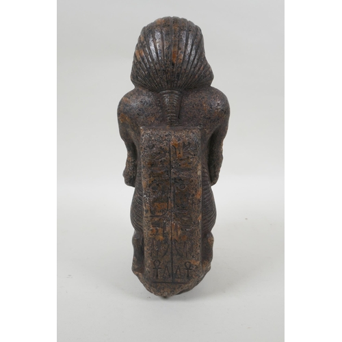 15 - An antique Egyptian carved granite figural statue with a tray of fish, hieroglyphic inscription vers... 