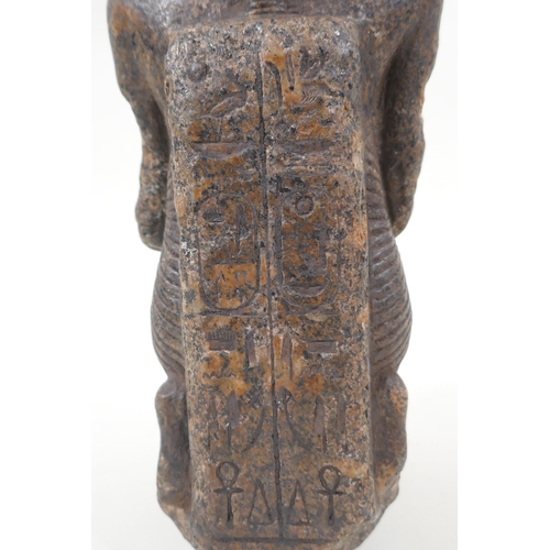 15 - An antique Egyptian carved granite figural statue with a tray of fish, hieroglyphic inscription vers... 