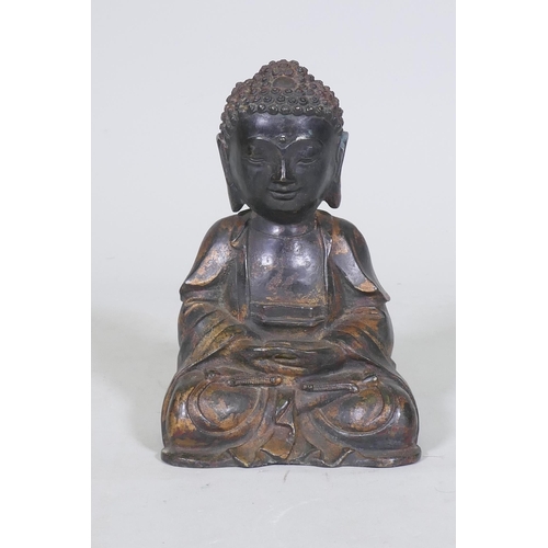 152 - An oriental painted and gilt brass figure of Buddha, 22cm high