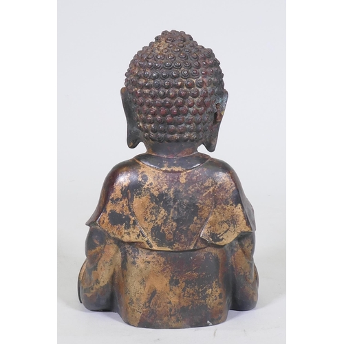 152 - An oriental painted and gilt brass figure of Buddha, 22cm high