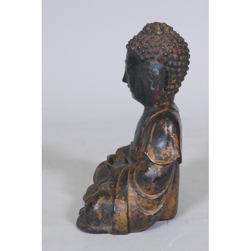 152 - An oriental painted and gilt brass figure of Buddha, 22cm high