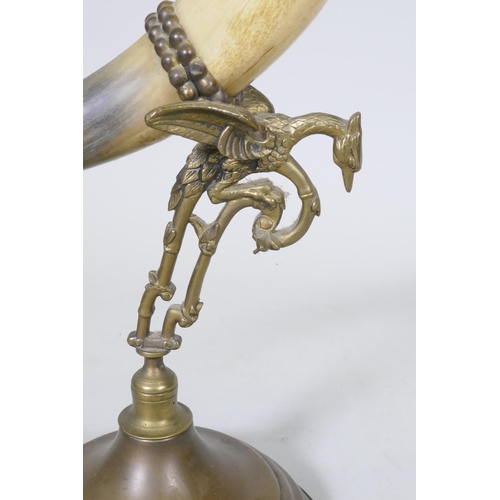 155 - Antique oil lamp with horn body and brass mounts and reservoir, 60cm high