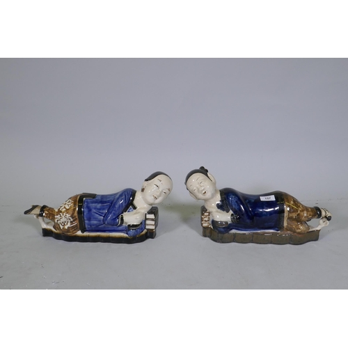 157 - A pair of Chinese ceramic pillows in the form of a recumbent boy and girl, 39cm long