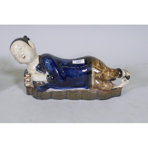 157 - A pair of Chinese ceramic pillows in the form of a recumbent boy and girl, 39cm long