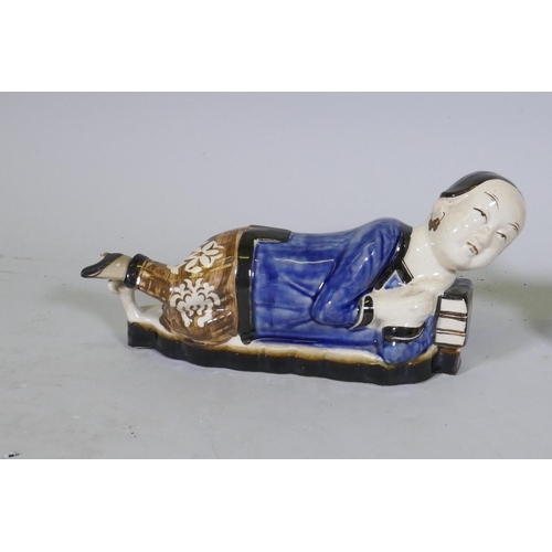 157 - A pair of Chinese ceramic pillows in the form of a recumbent boy and girl, 39cm long